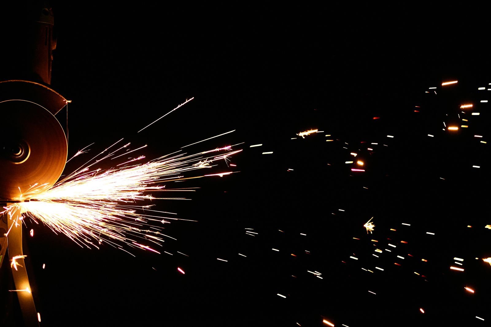 Angle grinder cutting stone with sparks flying